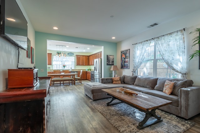 rental home with dark wood floors and cabinets, with faded paint on walls