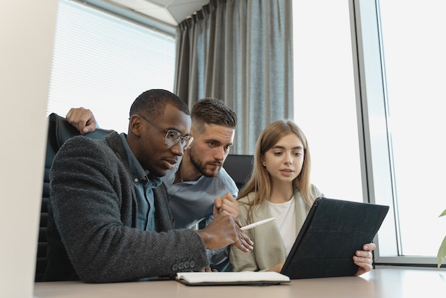three property experts looking over figures relating to the real estate market