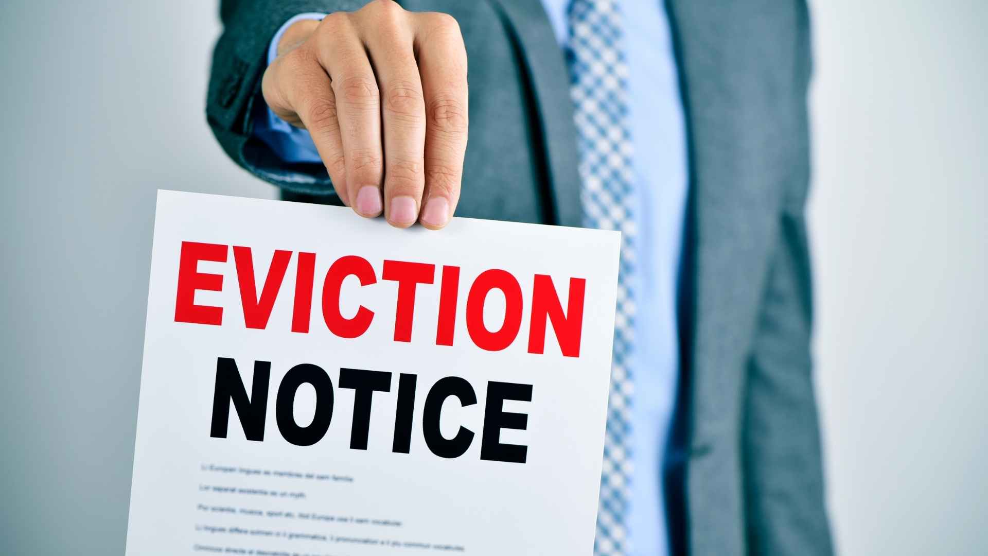 person holding up and eviction notice with the word eviction in red