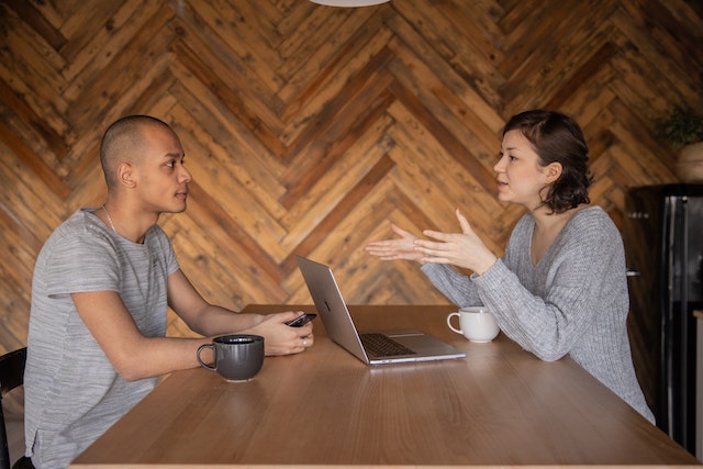 a landlord speaking with a tenant in their kitchen