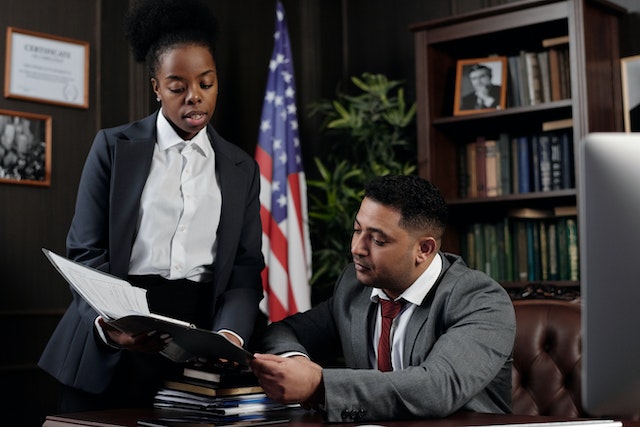 two people looking over laws in an office