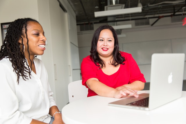 person in a red shirt meeting with someone in a white shirt