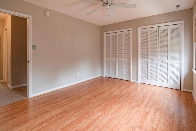 vacant-room-with-hardwood-floors-and-white-closet