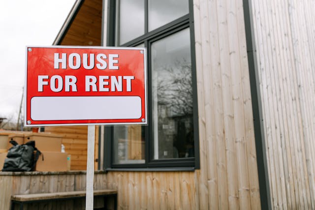 house-for-rent-sign-in-front-of-wooden-house