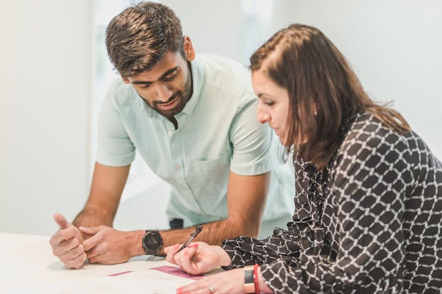 two people reading through documents